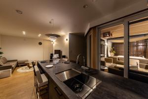 a kitchen with a sink and a living room at villa vacances hamanako in Hamamatsu