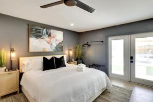 a bedroom with a white bed and a ceiling fan at Lytle Palm Studio in West Palm Beach