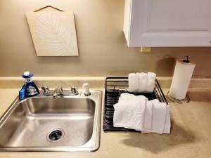 a kitchen sink with towels on a rack next to it at White Mountain Barn in Littleton