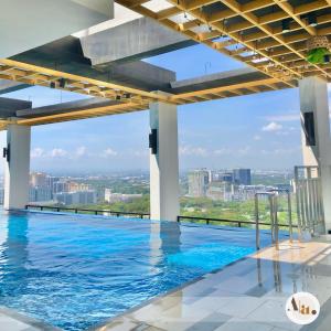 a swimming pool with a view of the city from a building at Abby's condotel in Manila