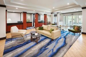 a living room with a couch and chairs on a blue rug at Fairfield Inn & Suites By Marriott Hinesville Fort Stewart in Hinesville