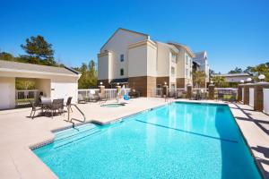 a swimming pool at a villa with a house at Fairfield Inn & Suites By Marriott Hinesville Fort Stewart in Hinesville