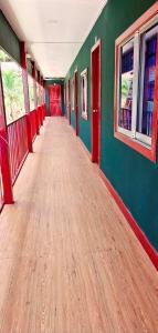 an empty hallway of a train with green and red walls at Lucky Leprechaun in Koh Rong Island