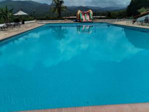a large blue swimming pool with a playground at LA PRIMAVERA 