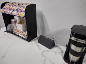 a counter with a cupcake holder and a box of donuts at Luxury In A Quaint Little Package in Oshkosh