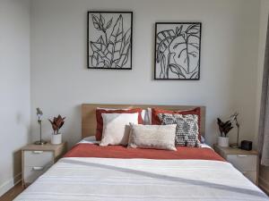 a bedroom with a bed with two pictures on the wall at A premier luxurious smart condo with parking in Seattle