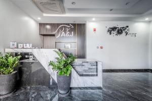 a lobby with two potted plants and a counter at A&J Kampot Boutique in Kampot +30 photos