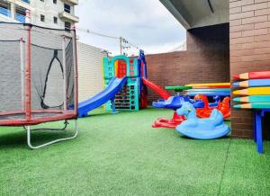 a backyard with a play area with a playground at Ap. c/ piscina 400m praia in Ubatuba