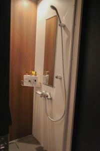 a shower in a bathroom with a mirror at Acoustic GARAGE by Tranova in Tokyo +23 photos