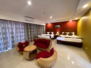 Ein Bett oder Betten in einem Zimmer der Unterkunft Aristocrat Residence & Hotel