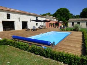 una piscina con inflables azules en una terraza de madera en La Grange d'Aunis, en Aigrefeuille-dʼAunis