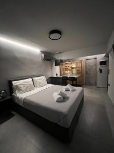 a bedroom with a large bed with towels on it at Loft Spa Greece - Enjoy our Jacuzzi & Hammam in Kalamata