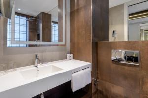 a bathroom with a white sink and a mirror at AC Hotel Venezia by Marriott in Venice