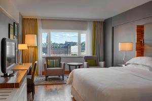 a hotel room with a bed and a window at Sheraton Stockholm Hotel in Stockholm