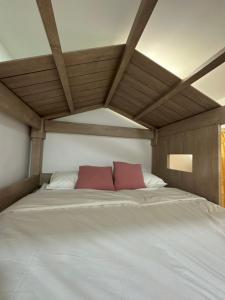 a large white bed with two red pillows on it at Summer View Apartment + Sky pool in Kuah +26 photos