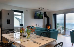 a living room with a table and a blue couch at Lanyon in St Ives