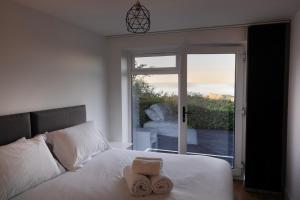 a bedroom with a bed with two towels on it at Lanyon in St Ives