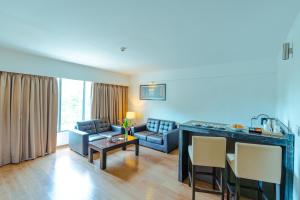 a living room with a couch and a table at Signature Club Resort in Devanahalli-Bangalore