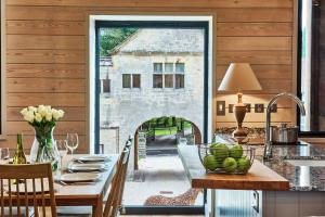 a dining room with a table and a fireplace at The Foal in Hexham