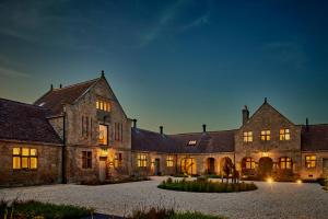 an old stone house with a courtyard at night at The Clocktower in Hexham