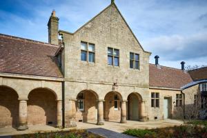 an old brick building with arches and a roof at The Stallion in Hexham