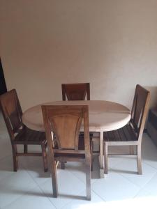 a wooden table with two chairs and a table and a table and chairsktop at MAZAPART in El Jadida
