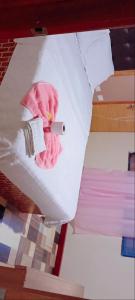 a close up of a bed with a pink blanket at Hotel la guaneña in Ipiales