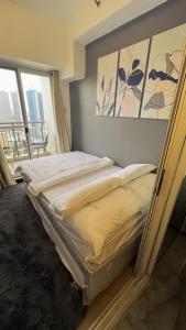 a bed in a room with avertisement for w obiekcie Condo w mieście Manila