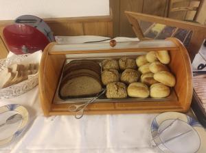 a wooden box filled with different types of bread at Hotel Aura am Schloss in Bad Pyrmont