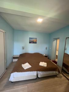 a bedroom with a large bed with two towels on it at Shabla Lux Guest Houses in Shabla