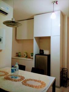 a kitchen with a table with two water bottles on it at Cozy Apartment 2 in Telipok Town