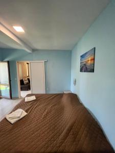 a bedroom with a large bed with a brown bedspread at Shabla Lux Guest Houses in Shabla