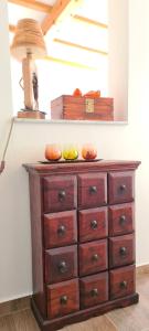 a wooden dresser with fruit on top of it at Apartman Lejla Vlašić in Vlasic +33 photos