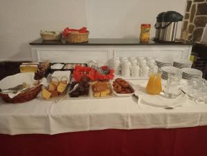 a table with a white table cloth with food on it at El Chisco in San Cosme
