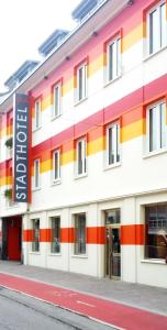 アムシュテッテンにあるStadthotel Gürtlerの看板が貼られたカラフルな建物