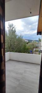a view of a balcony with a white wall at Aleks Holiday Rooms in Ksamil