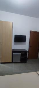 an empty room with a door and a microwave at Aleks Holiday Rooms in Ksamil