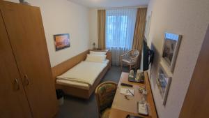 a hospital room with a bed and a desk at Gästehaus Ziegler in Stuttgart