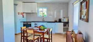 a kitchen with a wooden table and chairs in a room at Grandma´s House 