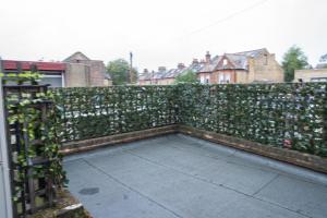 a privacy fence with ivy on it at Abeville Village Apartment in London