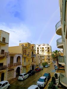 a view of a city with a rainbow in the sky at Hillock Residence Gozo Marsalforn in Marsalforn +18 photos