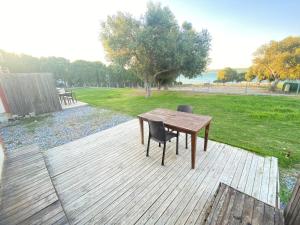 a wooden deck with a table and two chairs at Reds Bungalow in Didim