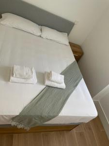 a white bed with two white towels on it at Exyca Bernabéu in Madrid