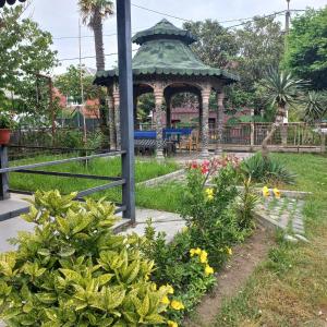 a gazebo in a park with flowers at Anna 2 in Kobuleti