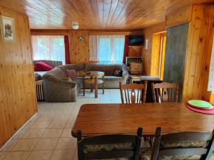 a living room with a table and a couch at Holiday House Vranov Dam in Oslnovice