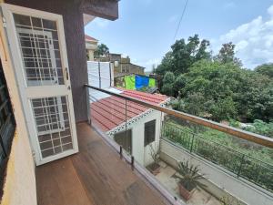 a balcony with a view of a house at Sai Tara Residency - Villa in Panhāla