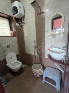 a bathroom with a toilet and a sink at Villa with valley view Panhala in Panhāla