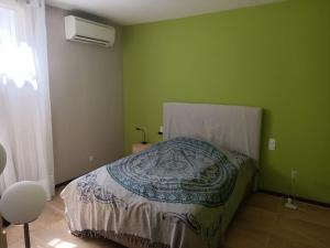 sypialnia z łóżkiem w zielonej ścianie w obiekcie Seaview 3 bedroom apartment with swimmingpool w mieście Cañet de Mar