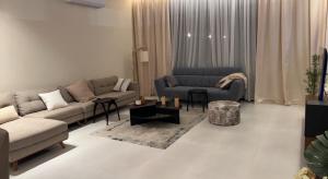 a living room with a couch and a chair at شاليه خاص فندقي و مستقل in Riyadh