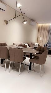a dining room with a table and chairs and a couch at شاليه خاص فندقي و مستقل in Riyadh